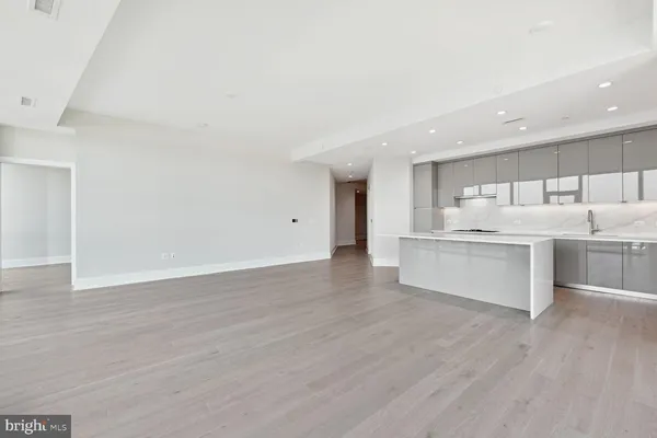 a view of kitchen with wooden floor and electronic appliances