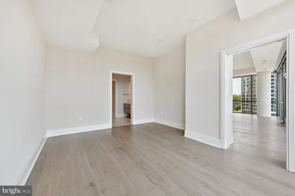 a view of a room with wooden floor
