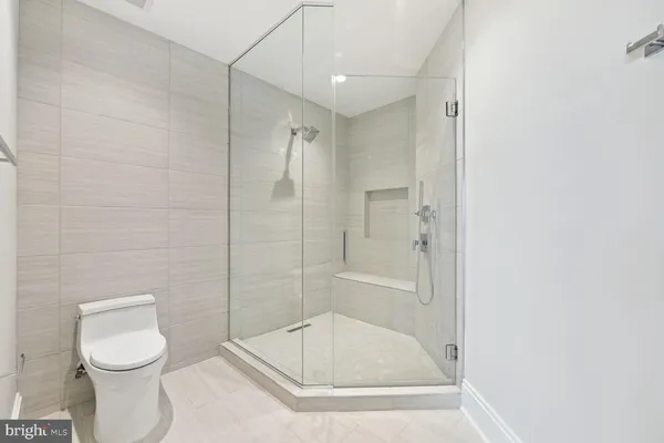 a bathroom with a toilet and shower