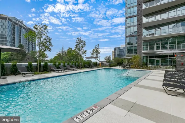 a view of swimming pool with outdoor seating and plants