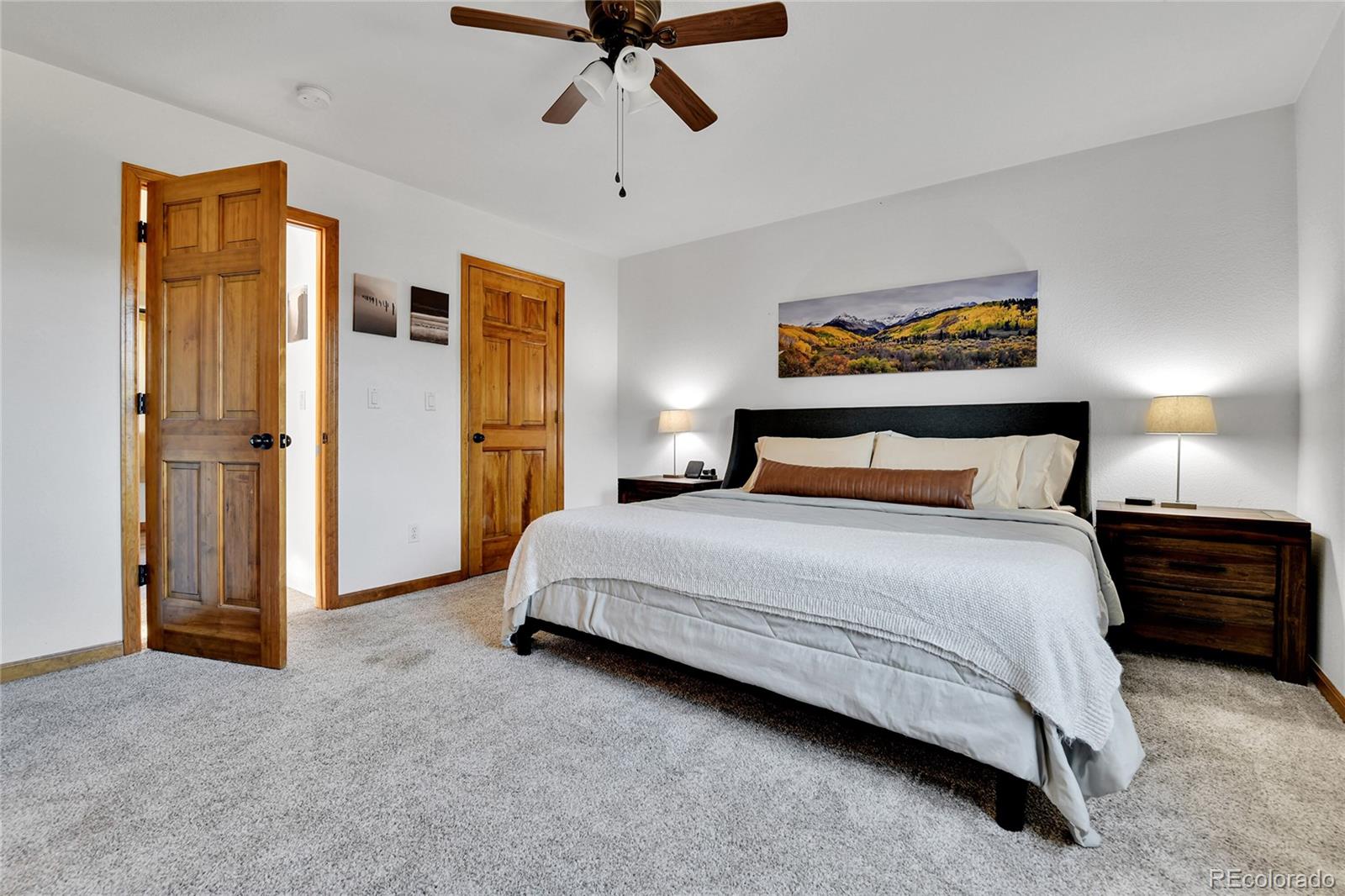 311 Nellie Road Bailey, CO 80421 - Photo 6 of 42 a bedroom with a bed and wooden floor