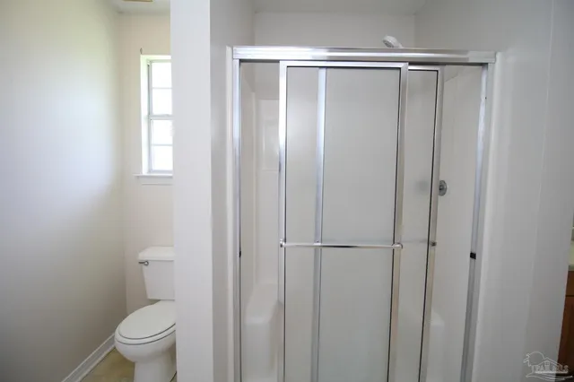 a bathroom with a glass door shower