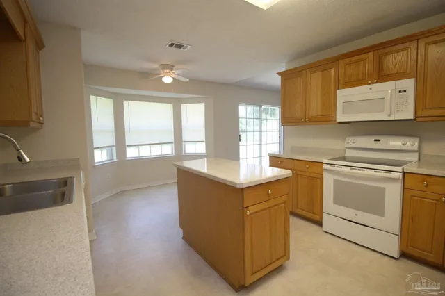 a kitchen with a stove microwave and sink