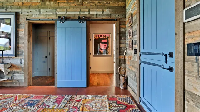 a kitchen with a stove a sink and a dining table with the view of living room