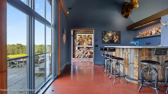 a balcony with furniture and a large window