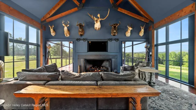 a view of swimming pool with lawn chairs and a yard