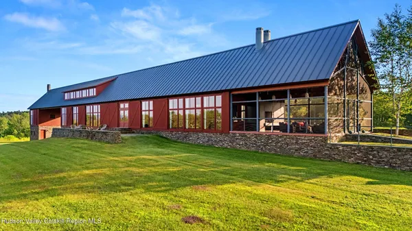 a view of a house with a yard porch and sitting area