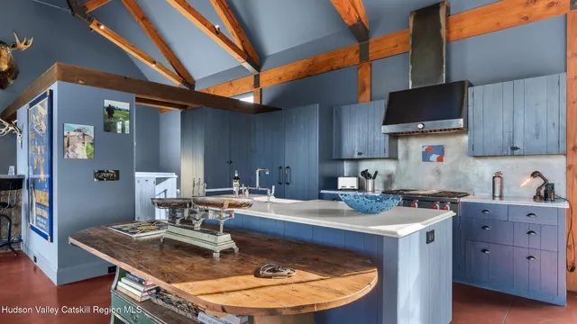 a living room with a rug floor to ceiling window and a fireplace