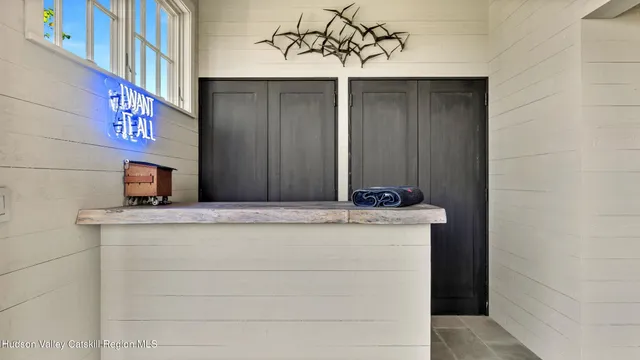 a view of staircase with two couches and a large window with outer view