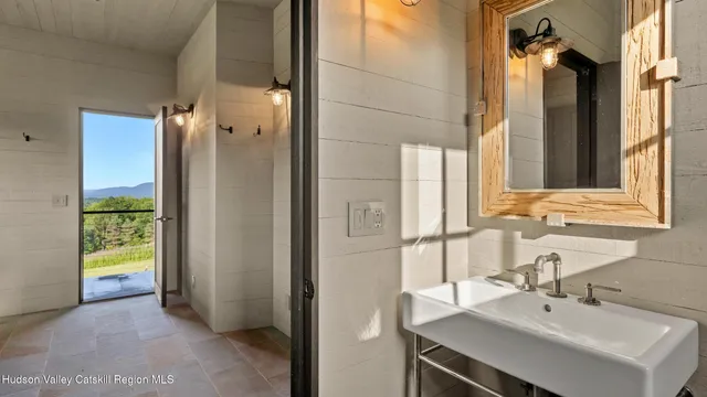 a living room with a bed and flat screen tv