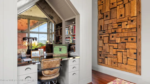 a view of a kitchen with furniture and wooden floor