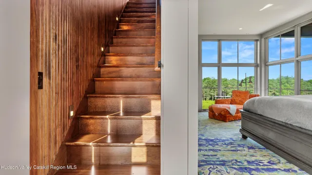a bedroom with furniture and a flat screen tv