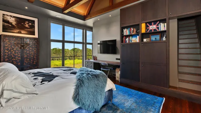 a bedroom with a bed next to a window with outer view