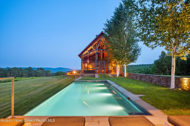 a view of hallway with wooden floor and a cabinet