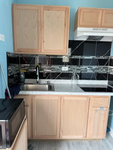 a kitchen with stainless steel appliances granite countertop a sink and a stove