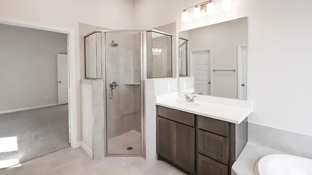 a bathroom with a sink toilet double vanity and tub