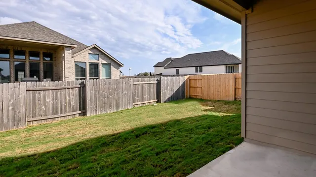 a view of a house with backyard and porch