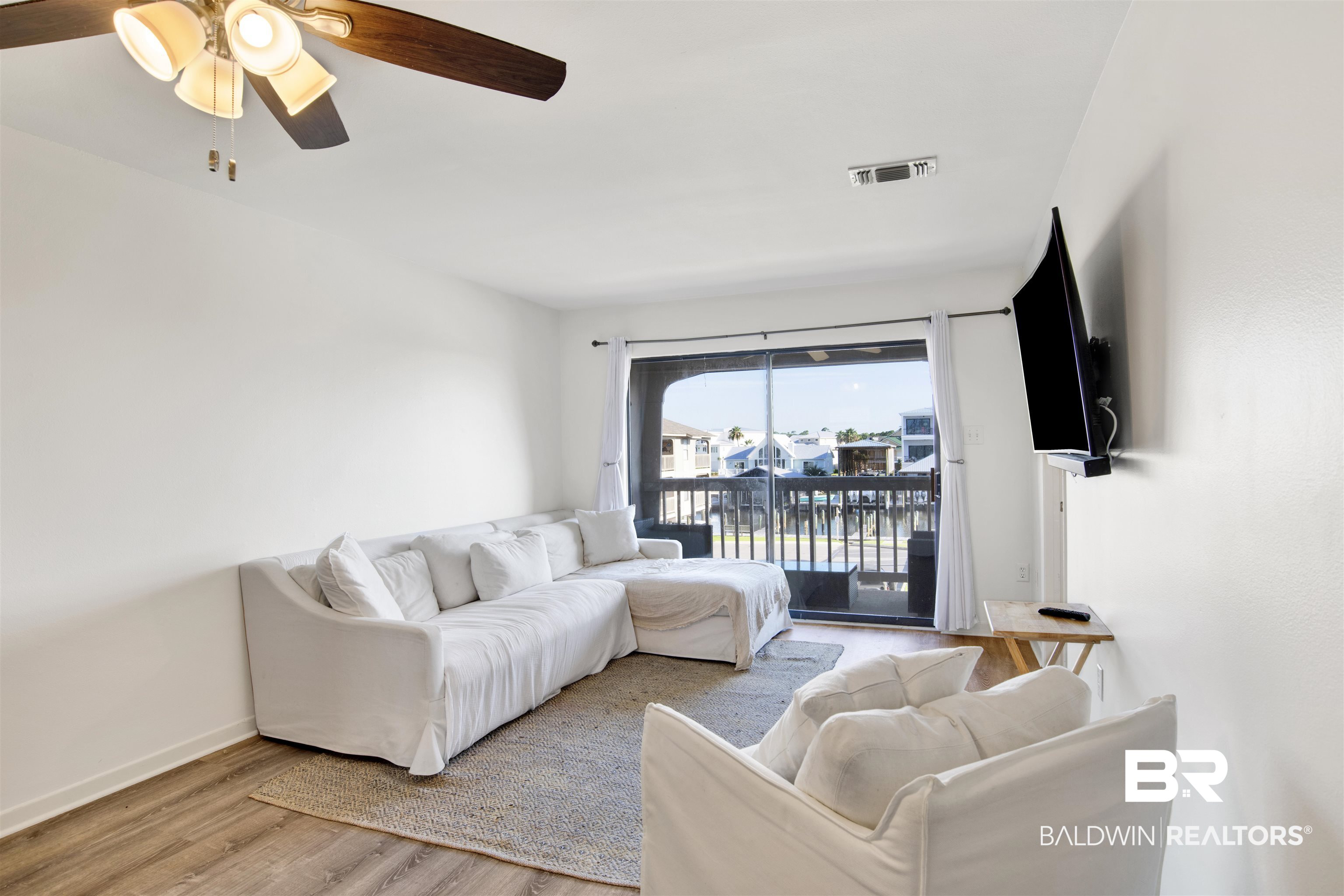 26913 Marina Road, Unit 213 Orange Beach, AL 36561 - Photo 6 of 30 Living room with ceiling fan and light hardwood / wood-style floors