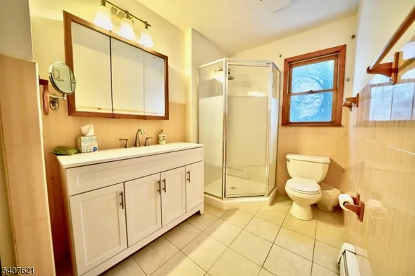 a bathroom with a granite countertop sink mirror and a toilet