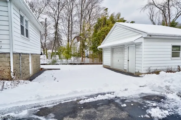 a view of a house with a yard covered in snow