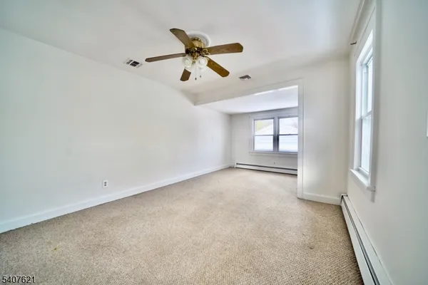 a view of a livingroom with a ceiling fan and window