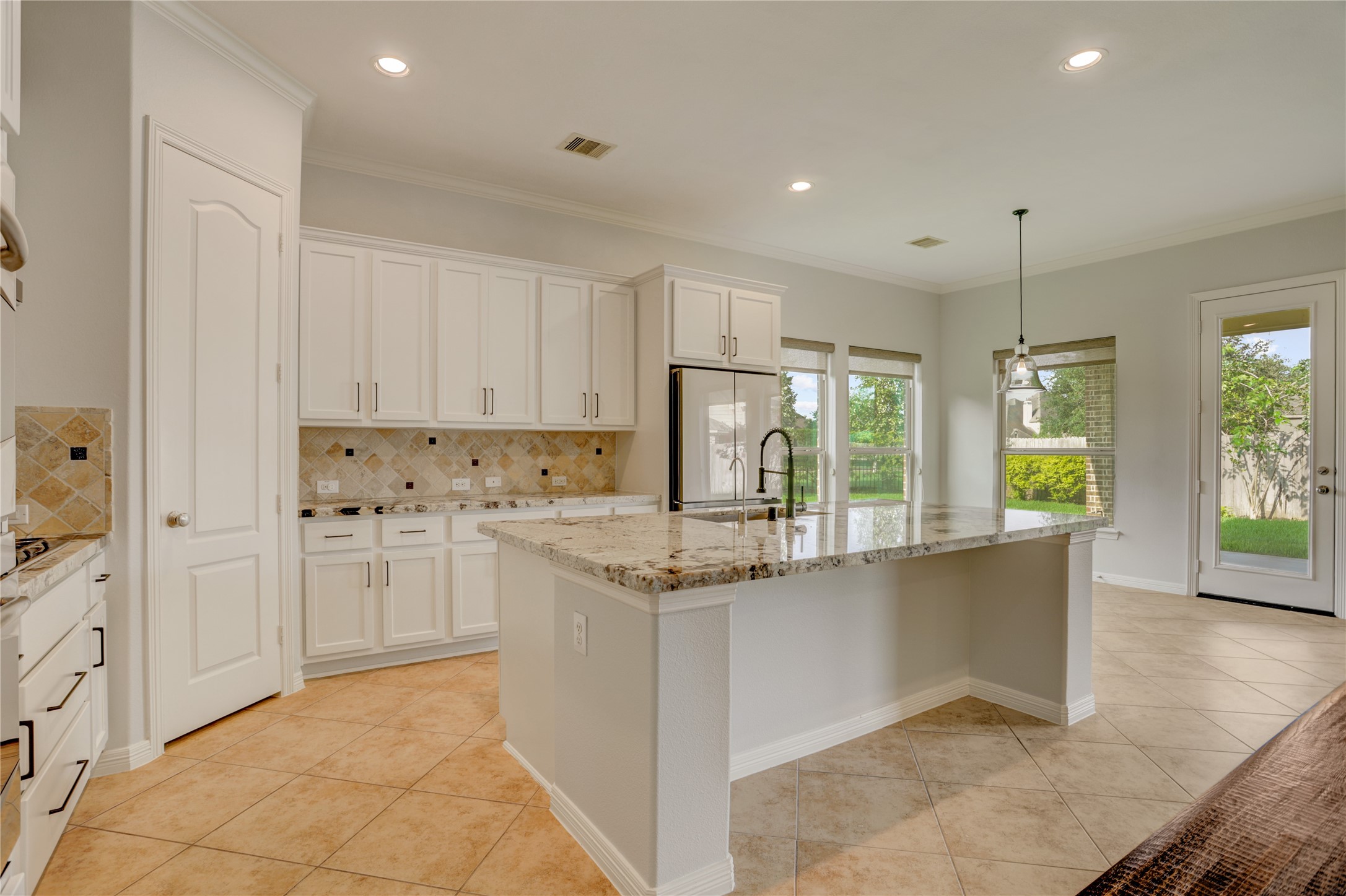 3002 Currant Drive Manvel, TX 77578 - Photo 8 of 43 a kitchen with stainless steel appliances granite countertop a stove a sink and a refrigerator