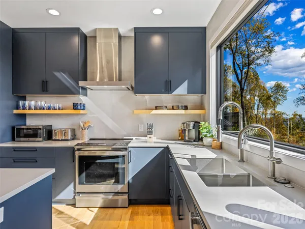 a kitchen with a sink stove and cabinets