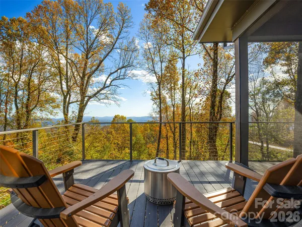 a view of a balcony with lake view and wooden floor