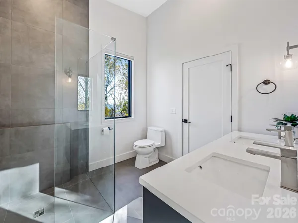 a spacious bathroom with a toilet sink and mirror