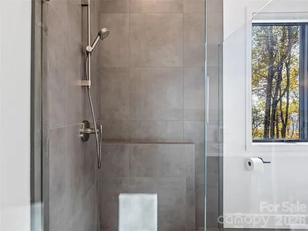 a bathroom with a glass shower door