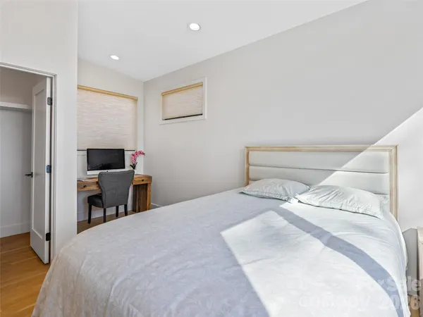 a bedroom with a bed and a chair