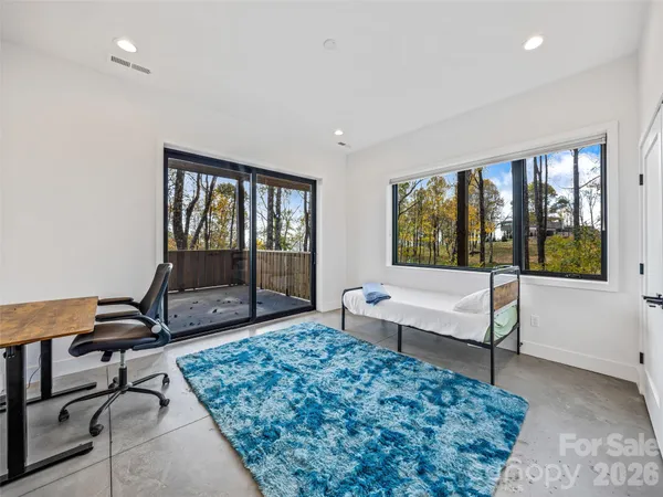 a living room with a couch and a floor to ceiling window