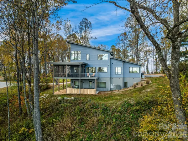 a view of a house with a yard and sitting area