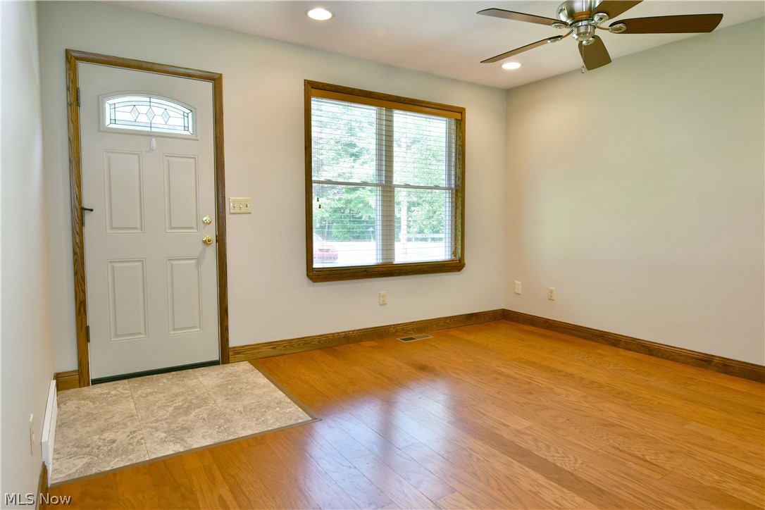 754 Warner Road Hubbard, OH 44425 - Photo 10 of 46 Entry area featuring wood-finish flooring, a white paneled entry door with decorative glass insert, and a tiled landing