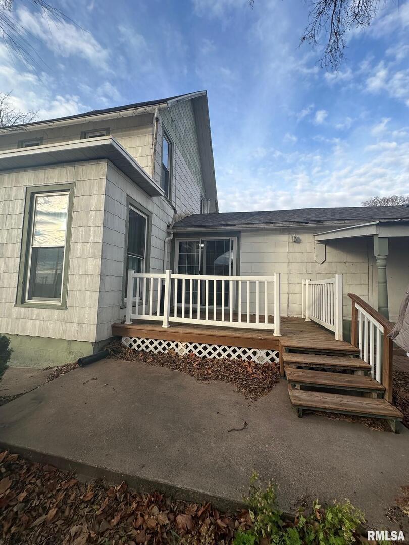 323 Lincoln Street Miles, IA 52064 - Photo 23 of 34 a view of a house with a deck and a yard