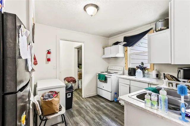 a kitchen that has a refrigerator and a stove in it