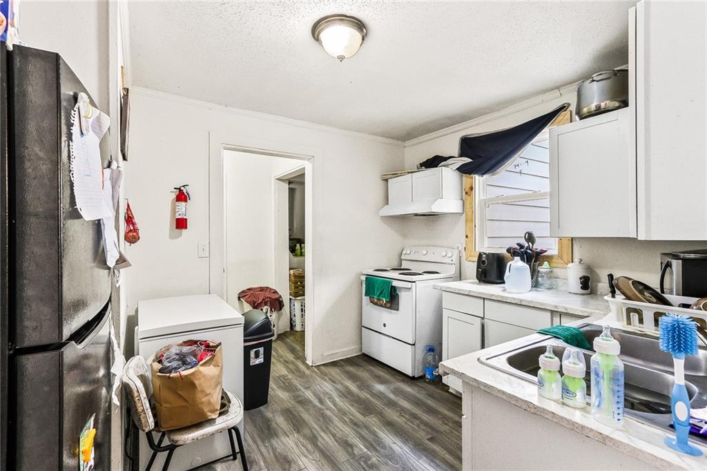 2231 Penelope Street Northwest Atlanta, GA 30314 - Photo 14 of 23 a kitchen that has a refrigerator and a stove in it