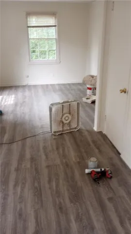 a room with wooden floor and window