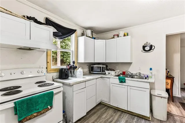 a kitchen with a stove a sink and a refrigerator