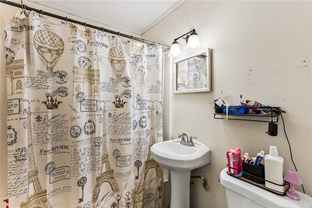 2231 Penelope Street Northwest Atlanta, GA 30314 - Photo 23 of 23 a bathroom with a sink and a mirror