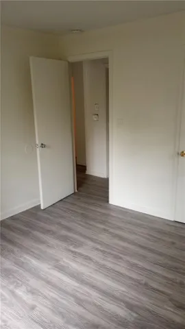 a view of an empty room and wooden floor