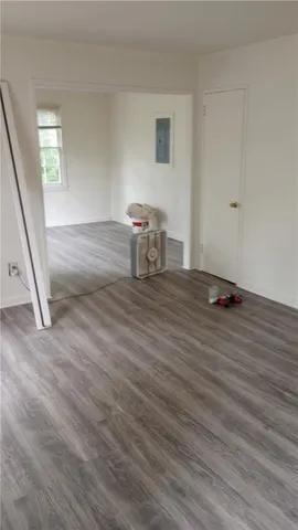 a view of a room with wooden floor