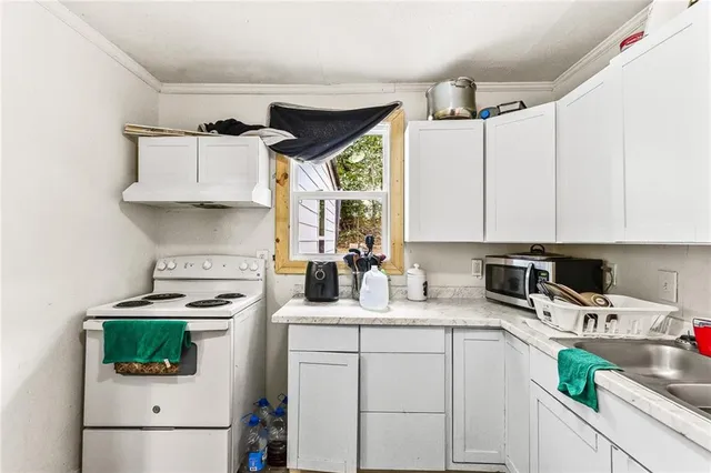 a kitchen with cabinets appliances and a sink