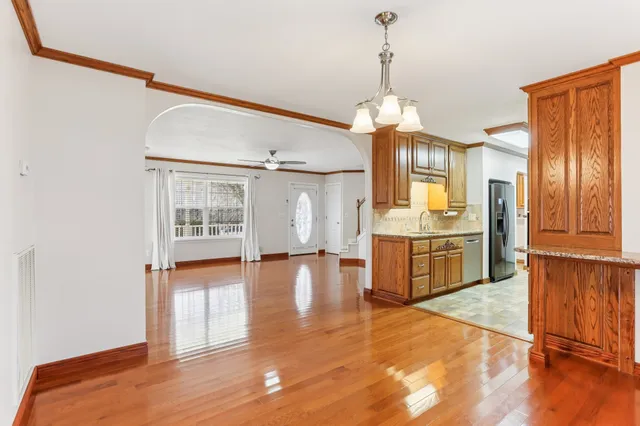 a view of a kitchen with a sink and cabinet with wooden floor