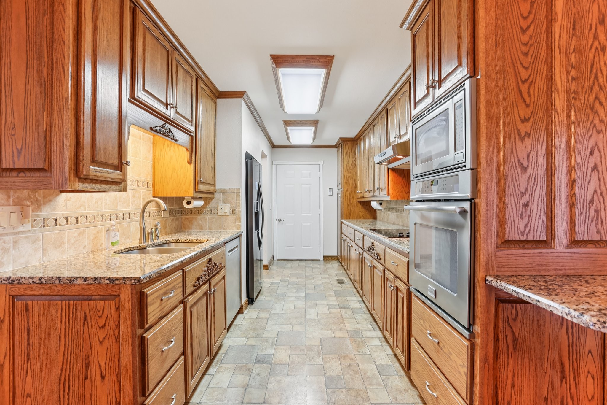 441 Marilyn Circle Spring Hill, TN 37174 - Photo 12 of 50 a kitchen with stainless steel appliances granite countertop a sink and dishwasher