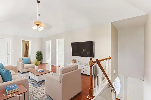 a living room with furniture a rug and a window