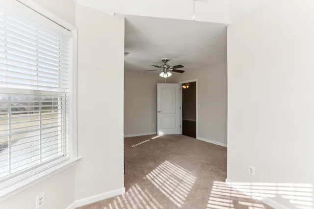 a view of a room with a ceiling fan