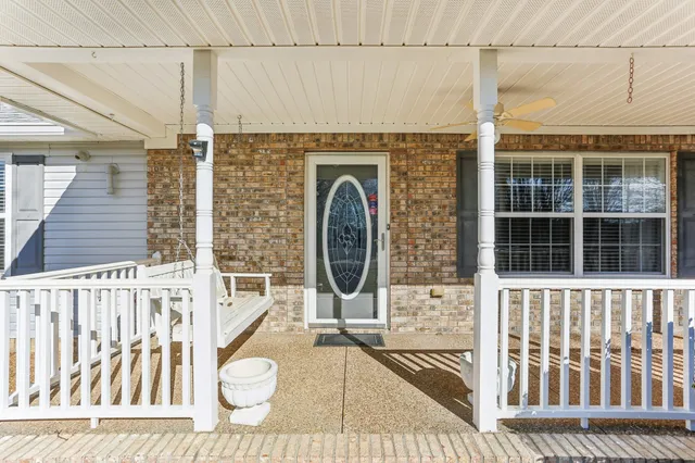 a view of a balcony with wooden floor and iron fence