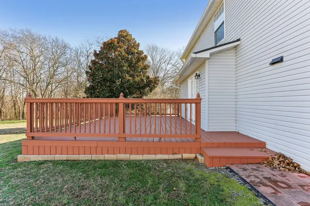 a view of backyard of house and car parked