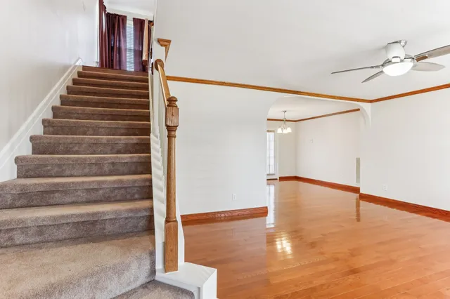 a view of entryway and hall with wooden floor
